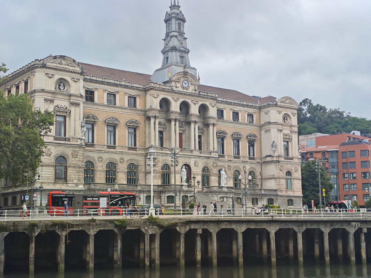 Una vista del histórico Ayuntamiento de Bilbao con cielos nublados sobre él, reflejando la grandeza arquitectónica de la ciudad.
