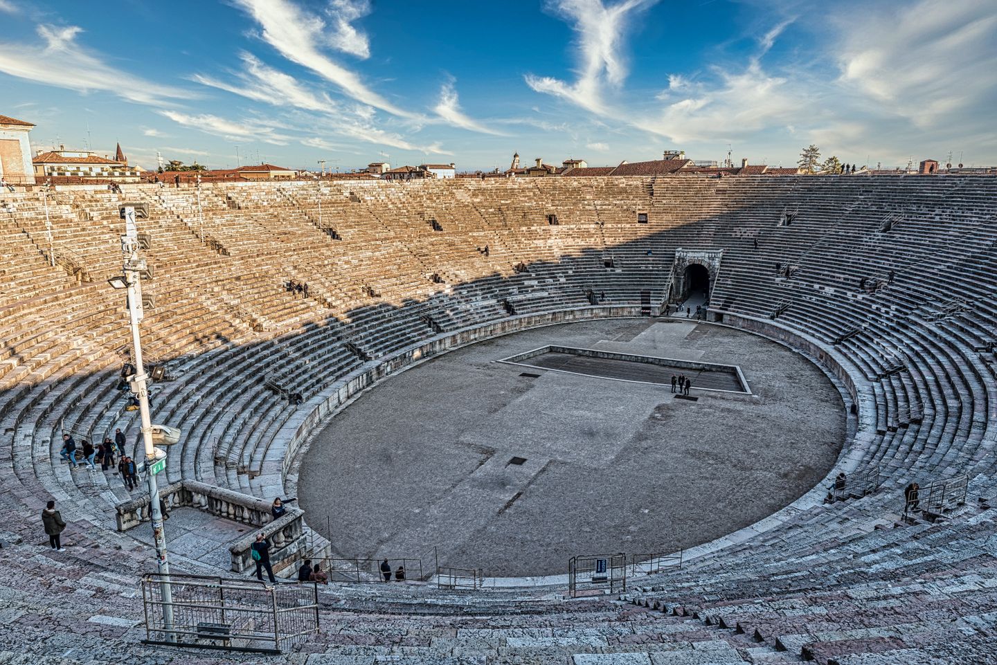 Impresionante vista del antiguo anfiteatro de Verona bañado por la luz del sol, mostrando su grandeza arquitectónica.